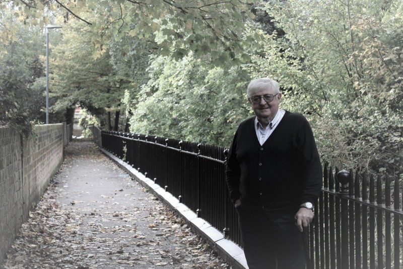 Image of Cllr John Lynch MBE admiring the repainted railings